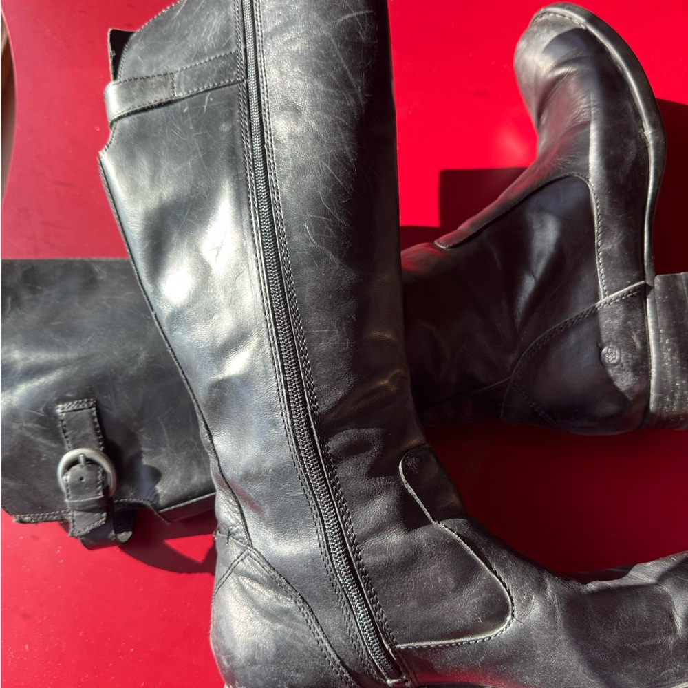 Born, black leather, knee-high boots.